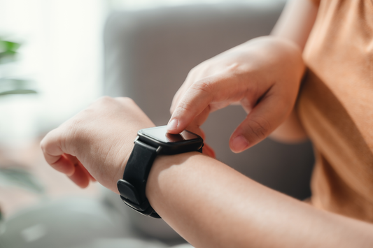 Woman checking an activity tracker on her wrist