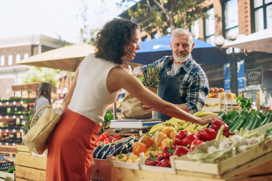 Woman browsing produce at a vegetable stand